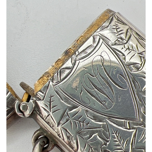 1210 - A Victorian silver vesta case with hanging ring and ivy leaf decoration to both front and back. Shie... 