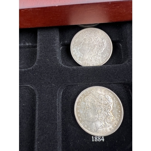 1218 - A wooden U.S. silver dollar collectors case with 9 Morgan Dollars for various dates and mints. San F... 