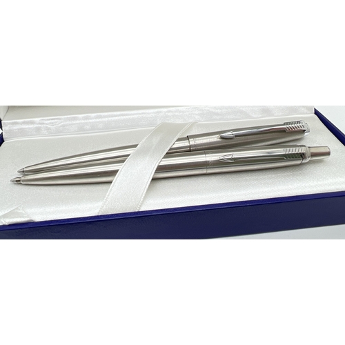 1222 - 4 stainless steel cased Parker ball point pens together with a blue ink refill.