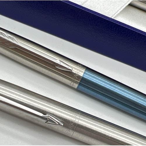 1222 - 4 stainless steel cased Parker ball point pens together with a blue ink refill.