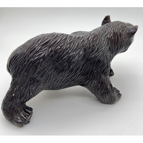 1229 - A hollow bronze figure modelled as a bear. Approx. 10.5cm tall x 22.5cm long.