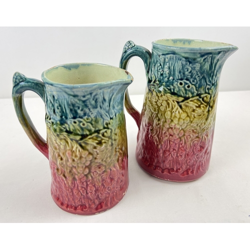 1259 - 2 vintage Majolica ceramic jugs with grape and vine decoration. In graduating colours of teal, lime ... 