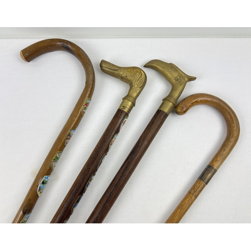 1293 - 4 vintage walking sticks to include brass handled and silver collared. A crook handled stick with Eu... 