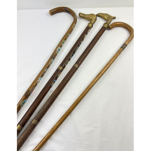 1293 - 4 vintage walking sticks to include brass handled and silver collared. A crook handled stick with Eu... 