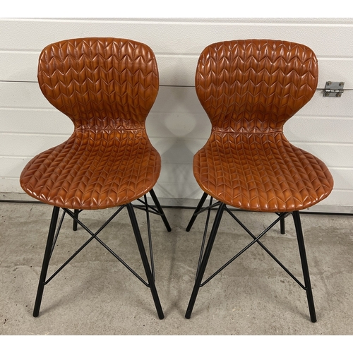 1369 - A pair of retro style black metal framed dining chairs with stitched leather seats and curved backs.... 