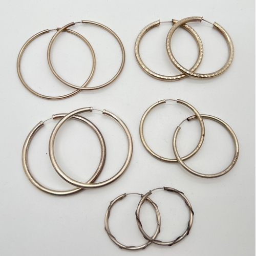 1139 - 5 pairs of large unmarked white metal hoop style earrings. Largest approx. 6cm diameter.