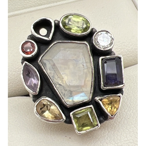 1030 - A modern design multi stone set silver ring (one stone missing). Stones cut in various shapes and si... 