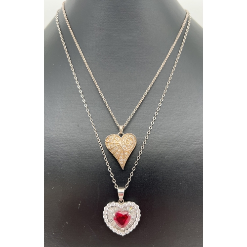 1010 - 2 stone set heart shaped pendant necklaces. A pendant with central heart shaped crated ruby surround... 