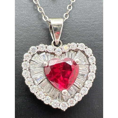 1010 - 2 stone set heart shaped pendant necklaces. A pendant with central heart shaped crated ruby surround... 