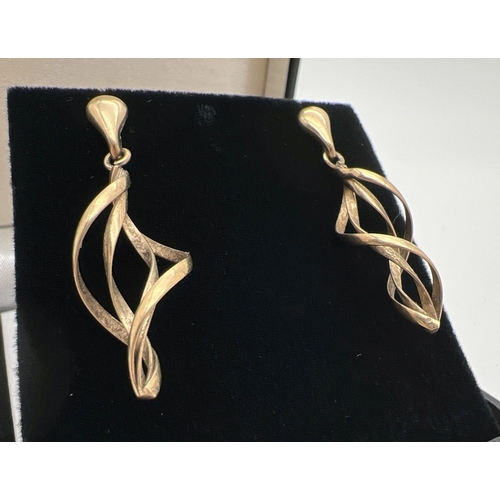 1027 - A pair of 9ct gold spiral twist drop style earrings, with butterfly backs. Hallmarked on posts. Appr... 