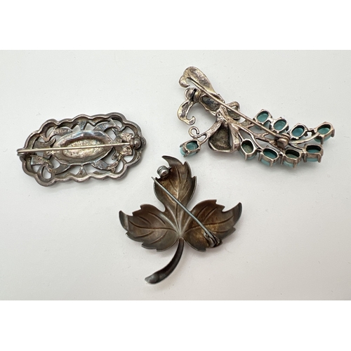 1028 - 3 vintage silver and white metal brooches. A rectangular pierced work brooch set with marcasite ston... 