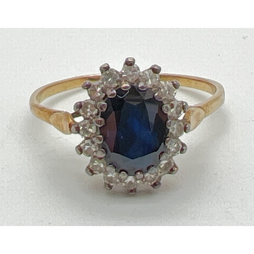 1004 - A 9ct gold, sapphire and diamond ring with central oval cut sapphire surrounded by 16 small round cu... 