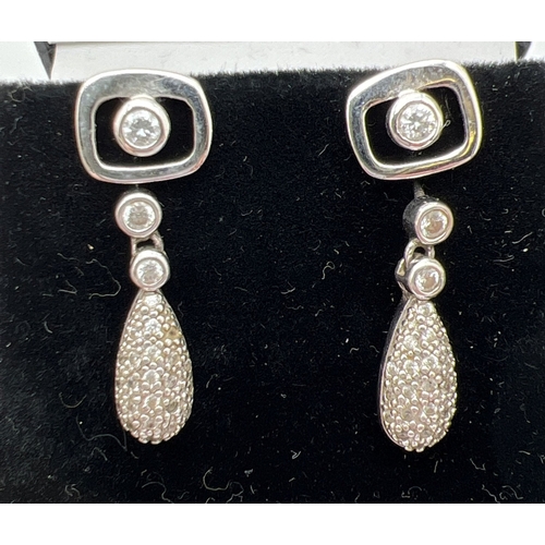 1046 - 5 pairs of modern design silver earrings in both stud and drop styles. To include shell set rectangu... 