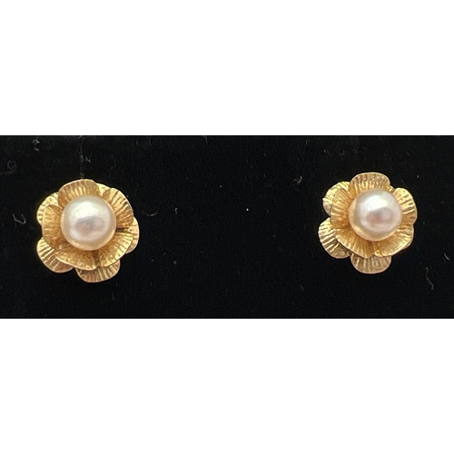 1049 - 3 pairs of unmarked gold stud style earrings. A pair of ball studs, a pair of flowers each set with ... 