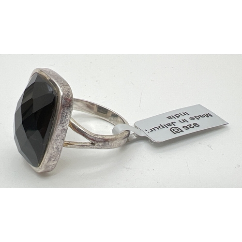 1051 - A silver dress ring set with a checkerboard cut black obsidian stone, new with tag. Silver marks ins... 