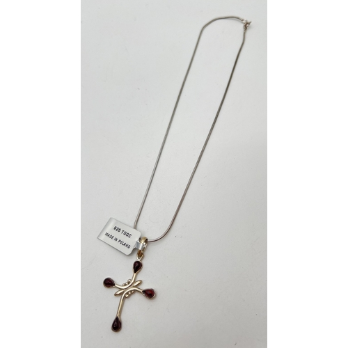 1060 - The Genuine Gem Company silver cross pendant set with 4 pear cut pieces of cherry amber. New with ta... 