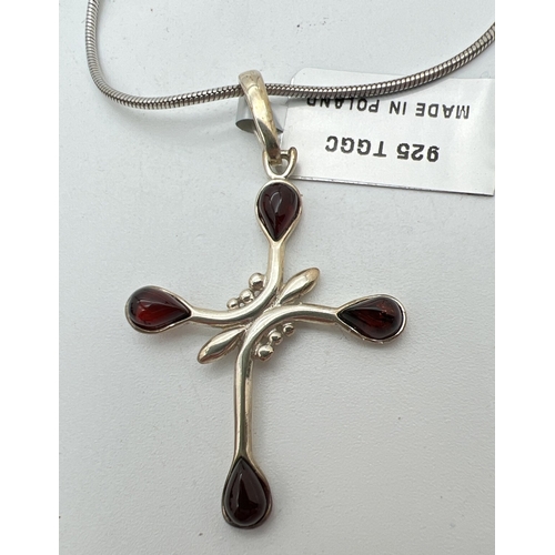 1060 - The Genuine Gem Company silver cross pendant set with 4 pear cut pieces of cherry amber. New with ta... 