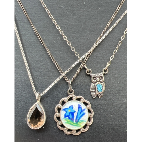 1063 - 3 silver pendant necklaces. A circular painted ceramic panel on a 16