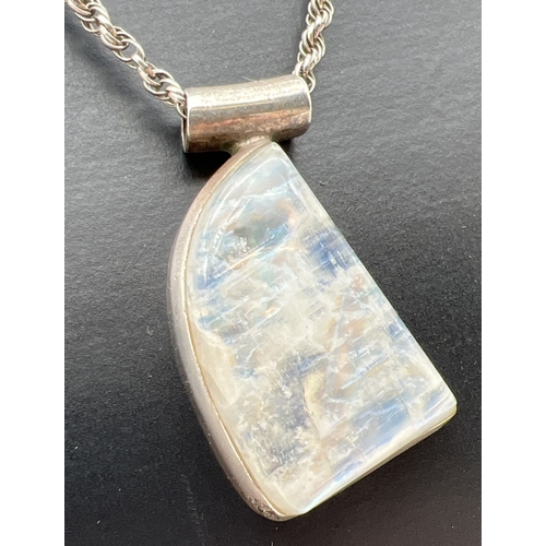 1070 - A modern design white metal and moonstone pendant, on an 18