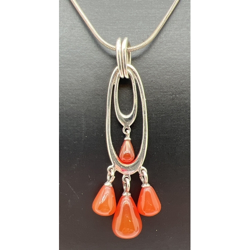 1074 - A silver modern design double oval drop pendant with 4 pear cut carnelian drops. On an 18