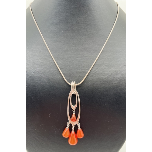 1074 - A silver modern design double oval drop pendant with 4 pear cut carnelian drops. On an 18