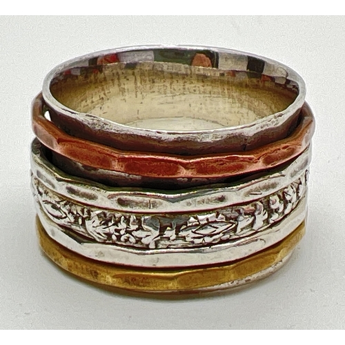 1076 - A silver modern design thick band spinner ring. Body of ring approx 1.75cm wide with 5 thin spinning... 