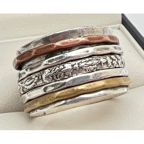 1076 - A silver modern design thick band spinner ring. Body of ring approx 1.75cm wide with 5 thin spinning... 