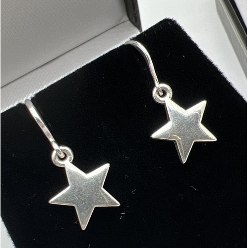 1077 - 3 pairs of silver and white metal drop style earrings with hooked posts. A pair of plain stars, a pa... 