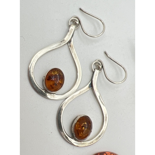 1081 - 3 items of Honey amber set silver jewellery. A brooch of an Art Nouveau style set with an oval amber... 