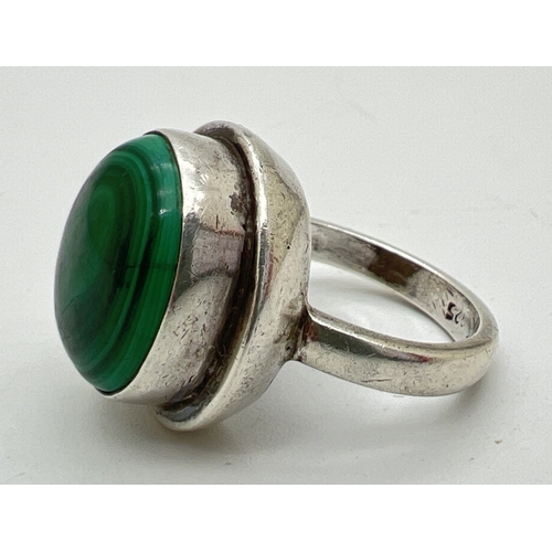 1083 - A large modern silver dress ring set with a round malachite cabochon in a stepped mount. Silver mark... 