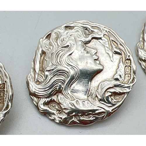 4 antique Art Nouveau silver buttons with floral and Mucha Lady head decoration to all. Hallmarked William Hayes, Birmingham 1902. Each button approx. 3cm diameter. Total weight approx 27.9g.