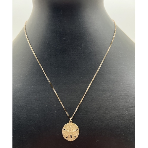 1085 - A vintage gilt sterling silver necklace by Danecraft. A circular pendant with starfish design and ha... 