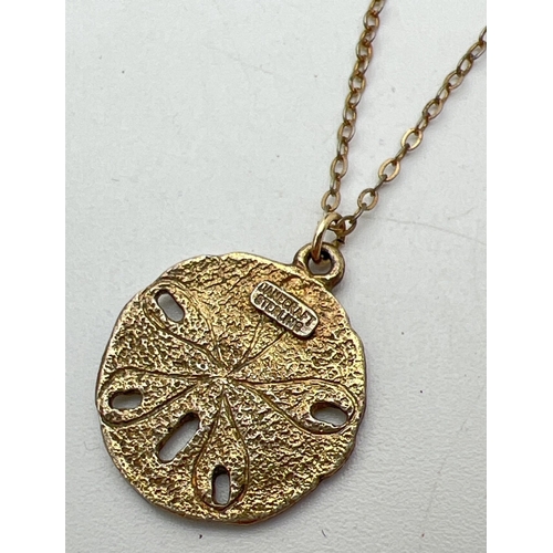 1085 - A vintage gilt sterling silver necklace by Danecraft. A circular pendant with starfish design and ha... 