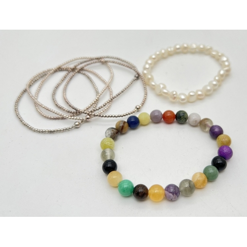 1090 - 7 elasticated bracelets.  A freshwater pearl bracelet, a multi semi precious stone and agate bracele... 