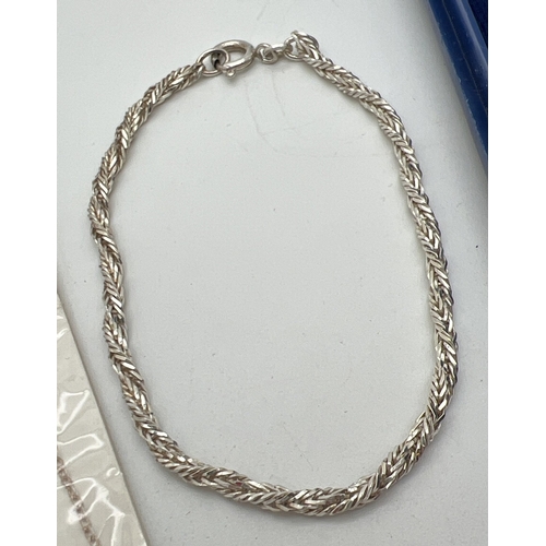 1093 - 2 silver chain necklaces together with a silver bracelet. A boxed 16