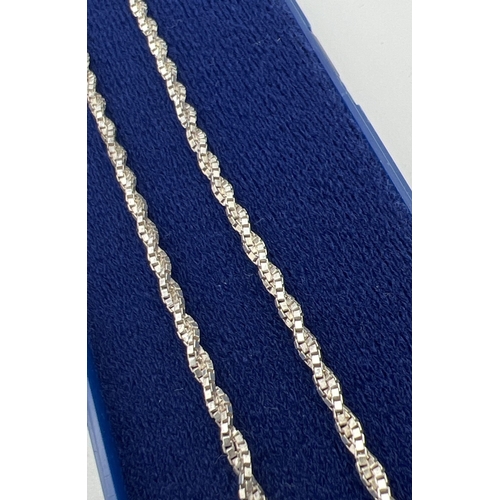 1093 - 2 silver chain necklaces together with a silver bracelet. A boxed 16