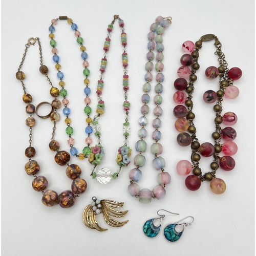 1094 - A small collection of vintage costume jewellery, mostly glass bead necklaces. To include a multi col... 