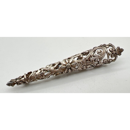 1097 - A vintage white metal boutonniere posy brooch with decorative floral design pierced work detail. App... 