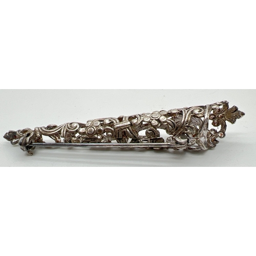 1097 - A vintage white metal boutonniere posy brooch with decorative floral design pierced work detail. App... 