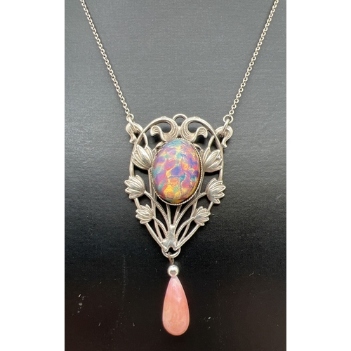 1099 - An Art Nouveau design fixed pendant necklace with floral pierced work design, foil glass cabochon an... 