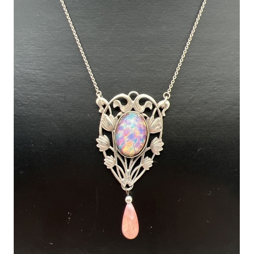 1099 - An Art Nouveau design fixed pendant necklace with floral pierced work design, foil glass cabochon an... 