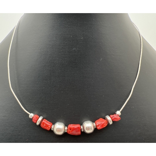 1101 - An Italian silver and red coral beaded necklace on a silver wire, with matching bracelet. Both stamp... 