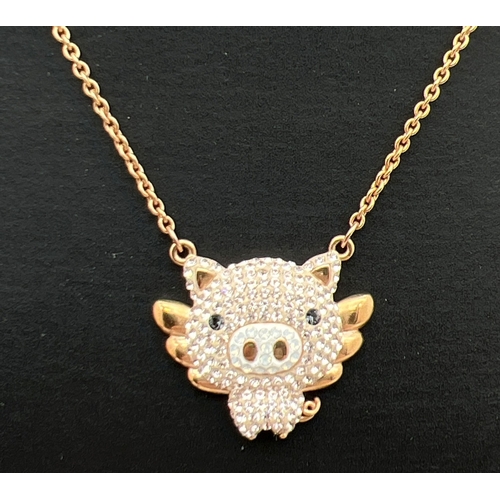 1105 - A Swarovski crystal set rose gold plated 'Little pig' fixed pendant necklace. On a 14