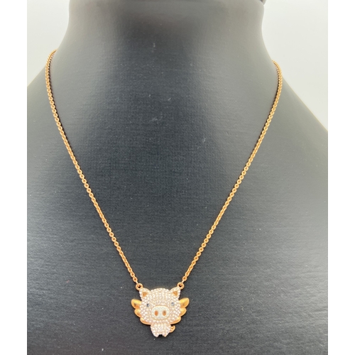 1105 - A Swarovski crystal set rose gold plated 'Little pig' fixed pendant necklace. On a 14