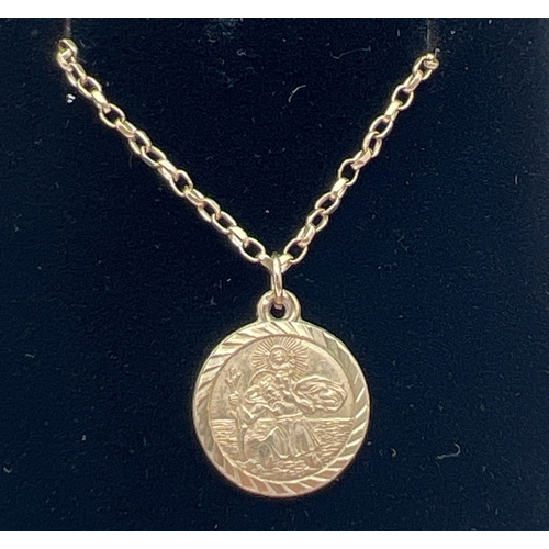 1108 - A 9ct gold circular shaped St. Christopher pendant on a 24