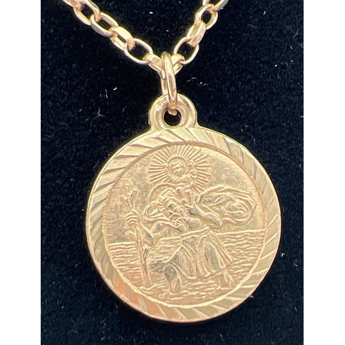 1108 - A 9ct gold circular shaped St. Christopher pendant on a 24