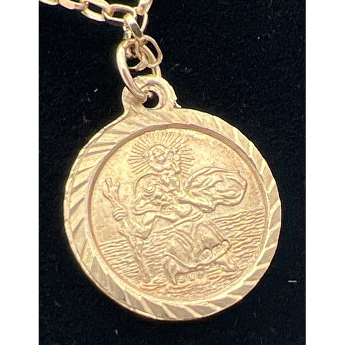 1108 - A 9ct gold circular shaped St. Christopher pendant on a 24