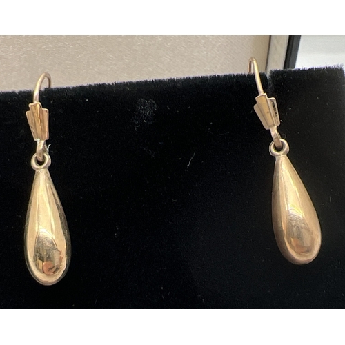 1116 - A pair of 9ct gold teardrop shaped drop earrings with hooked wire posts. Fully hallmarked on wires. ... 