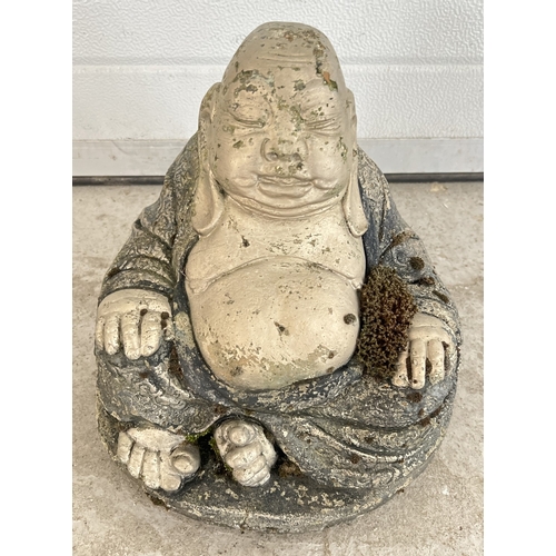 1413 - A painted concrete garden ornament of sleeping Buddha. Approx. 26cm tall.