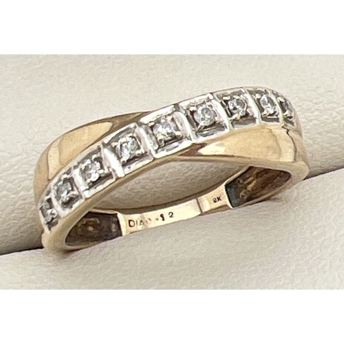 1120 - A 9ct gold and 12 point diamond eternity style ring with a twist design setting. 9 small round cut d... 